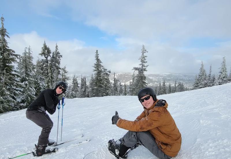 Two students on skiis at a ski slope.